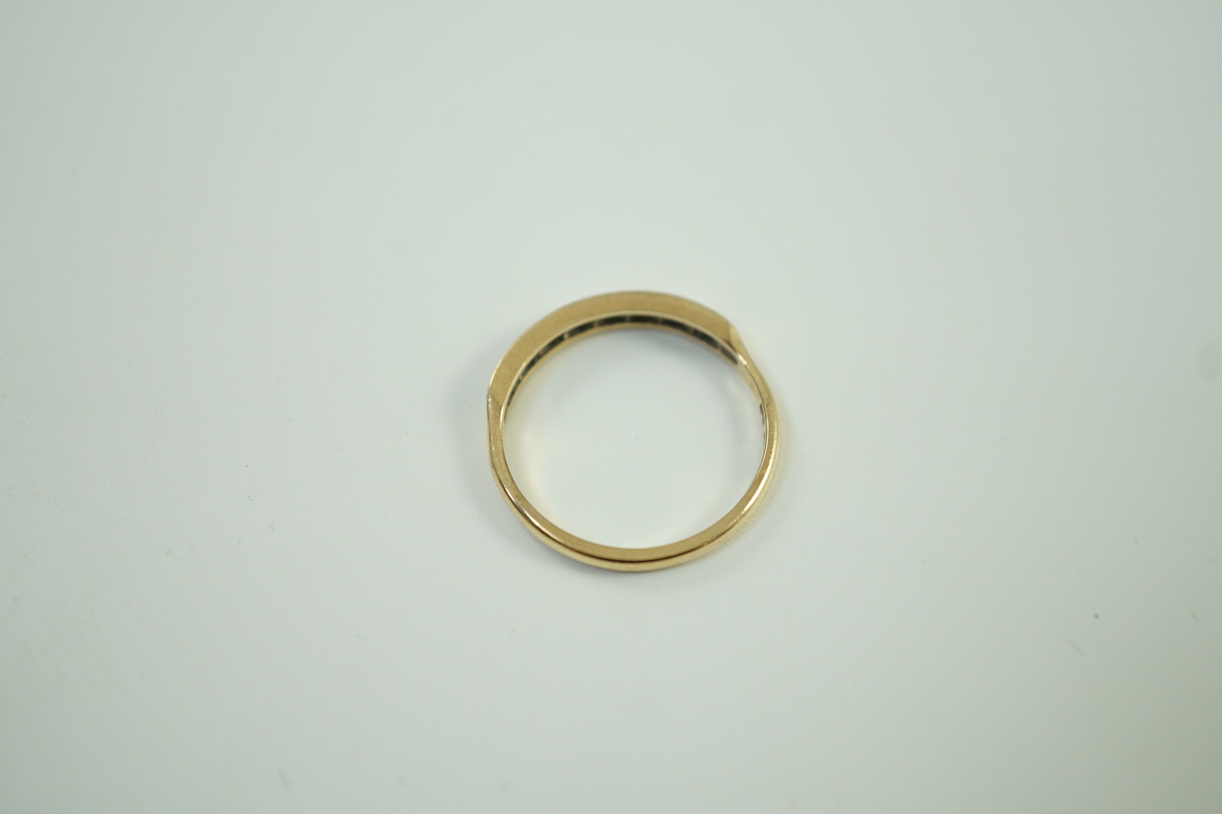 A modern 9ct gold and eight stone diamond chip set half hoop ring, size O, gross weight 1.6 grams.